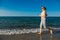 Middle-aged woman running on beach