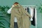 Middle aged woman shopping new dress clothes shelf green