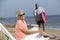 Middle-aged woman sitting on a deckchair on a beach