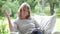 Middle Aged Woman Sitting Outdoors Reading Book