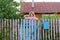 Middle-aged woman stands at the gates country