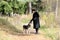 Middle-aged woman stroking a dog for a walk