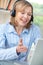 Middle Aged Woman Talking Online Using Headset