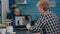 Middle aged woman talking video conference with children