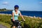 Middle-aged woman training riding bicycle at the sea