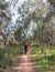 Middle-aged Woman Walking Along Bush Track.