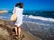 Middle-aged woman walking on beach