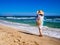 Middle-aged woman walking on beach