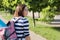 Middle-aged woman walking outdoor on road in park