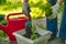 middle aged woman working with soil pot with sprouts planted in it at the backyard houses