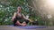 Middle aged woman yoga on wooden deck outdoor in nature. Health and wellness. Sports and recreation concept.