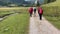 middle-aged women hiking on alpine footpath