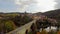 Middle ages castle village with moat river bridge, aerial, roofs