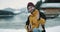 In the middle of amazing lake and snowy forest and mountain happy and charismatic tourist closeup sitting in a boat and