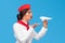 Middle East stewardess throwing paper airplane