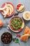 Middle Eastern and Arab food tabbouleh salad, pita, melon, peach and dates on a gray background. Top view, flat lay