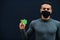 Middle eastern man in gray turtleneck and black face protect mask show Turkmenistan flag isolated background