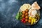 Middle Eastern meze platter with falafel, pita, hummus, pickles, radishes. Mediterranean or greek appetizer party