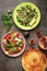 Middle Eastern salads tabbouleh and fattoush, pitta bread, pomegranate, figs on a dark rustic background. Arabic dishes, top view