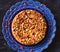 Middle eastern style walnut raisin cake in blue pottery