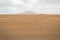 In The Middle of Nowhere written on the sand of Desert. Sal Island, Cape Verde. On background Pico do Fogo, Volcano