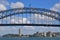 Middle portion of Sydney Harbour Bridge with buildings and green park in the background