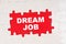 In the middle of the puzzles on a red background it is written - DREAM JOB