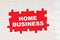 In the middle of the puzzles on a red background it is written - HOME BUSINESS