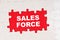 In the middle of the puzzles on a red background it is written - SALES FORCE