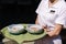 Middle selection of waitress hold two portion of soup on a tray. Fresh vegan soup in restaurant. Service