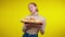 Middle shot of charming slim redhead woman posing with tray of bread and croissants at yellow background. Portrait of