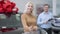 Middle shot of confident satisfied female buyer turning to camera smiling and stretching car key. Portrait of happy