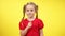 Middle shot of cute charming little girl shaking finger in slow motion disapproving. Portrait of beautiful confident