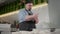 Middle shot of focused professional cook in hat and apron forming pinza dough in kitchen. Portrait of concentrated