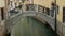 Middle shot of footbridge over water canal in Venice, Italy