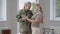 Middle shot of loving happy woman and military man talking and hugging at home. Portrait of positive Caucasian middle