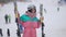 Middle shot portrait of funny cheerful woman dancing in slow motion at snowy slopes outdoors. Happy young slim Caucasian