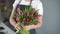 Middle shot portrait of girl florist making floral composition from fresh tulips