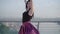 Middle shot of positive ballerina spinning with hands up. Portrait of smiling young Caucasian woman dancing in the