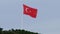 Middle shot of turkish national red flag waving fast in wind on the hill
