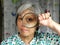 middleage woman holding magnifier