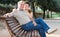 Middleaged male and female posing on bench