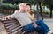 Middleaged male and female posing on bench