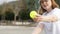 middleaged woman playing pickleball game with paddle and pickleball yellow ball, outdoor sport leisure activity.