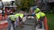 Middlebury, Vermont - 20181010 - Construction Crew Smooths Concrete In Newly Poured Cement Sidewalk.