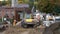 Middlebury, Vermont - 20181010 - Construction Crew Smooths Ramp With Catepillar While Partner Waters Dirt.