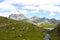 Midi d\'Ossau peak behind another mountain and a lake