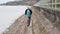 Midle aged man running on the shore of the lake. Solitude mature man running on the bank. Concept of active man