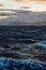 The Midnight sun over the icebergs of the Drake Passage near the Antarctic Peninsula in Antarctica.