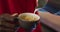 Midsection of african american barista pouring milk from jar into coffee cup in cafe